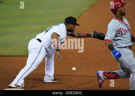 Miami Marlins' Jean Segura, left, is out at the plate on a throw from  Philadelphia Phillies second baseman Bryson Stott to catcher J.T. Realmuto,  right, during the eighth inning of a baseball