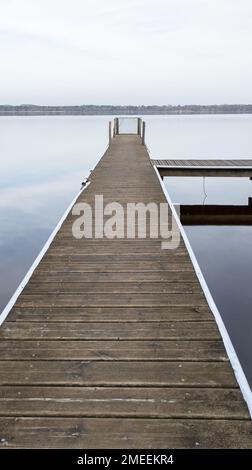 wood pontoon boat empty in french Leon lake water in southwest france Stock Photo