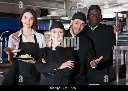 Team of restaurant staff in kitchen Stock Photo