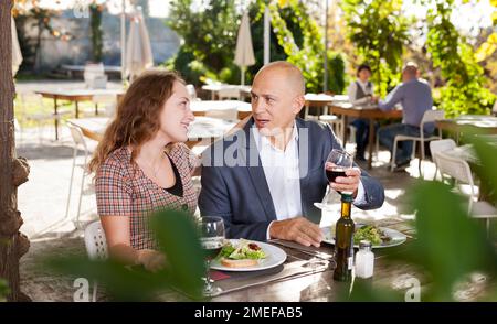 Adult couple having lunch at summer cafe terrace Stock Photo