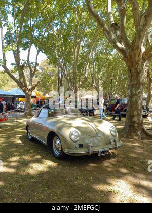 Old sport 1959 Porsche 356 A two door convertible in a park. Nature, grass, trees. Autoclasica 2022 classic car show. Copyspace Stock Photo