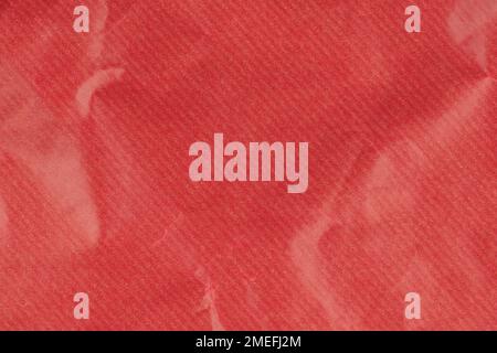 Crumpled red gift wrapping paper texture close up. Abstract background Stock Photo
