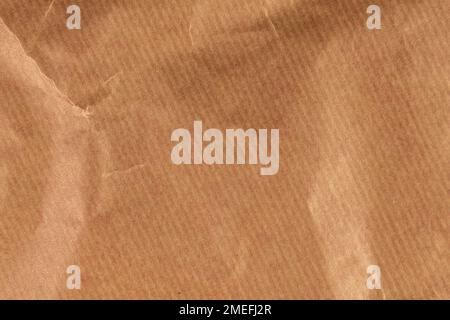Crumpled recycled brown wrapping paper texture close up Stock Photo