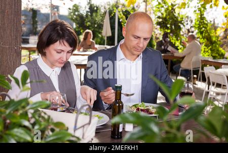 Adult couple having lunch at summer cafe terrace Stock Photo