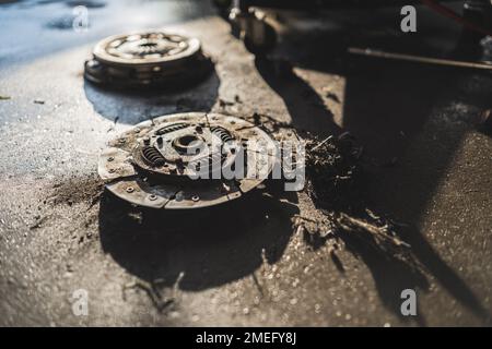 Close shot of two broken car clutch lying on the floor. Repair shop concept. High quality photo Stock Photo