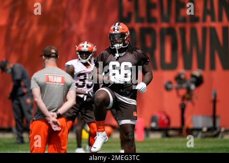 Cleveland Browns tackle James Hudson III warms-up drill during an