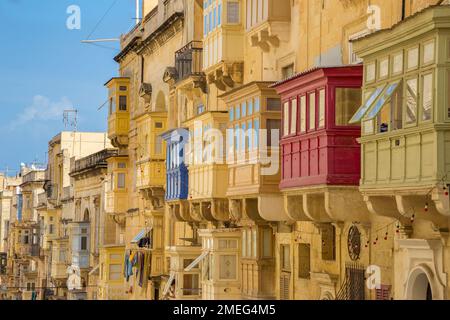 Valletta, Malta - Ancient Maltese houses and traditional colorful balconies of Valletta on a sunny summer day with clear blue sky Stock Photo