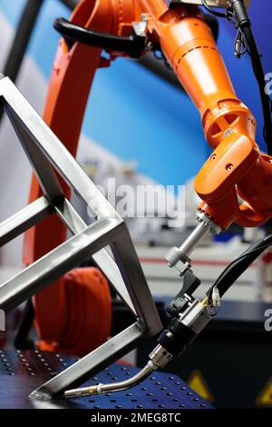 6 axis industrial welding system with robotic arm. Selective focus. Stock Photo