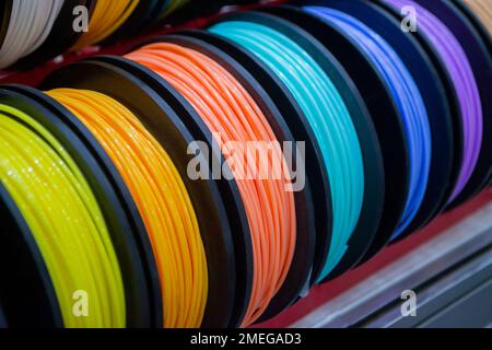 Many multi-colored spools of thread of filament for printing 3d printer. Material coils for printing 3D printer. Spools of 3D printing motley different colors filament. ABS wire plastic for 3d printer Stock Photo