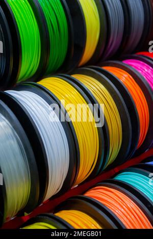 Many multi-colored spools of thread of filament for printing 3d printer. Material coils for printing 3D printer. Spools of 3D printing motley different colors filament. ABS wire plastic for 3d printer Stock Photo