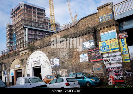 The tall high-rise residential development  called Higgs Yard, rises with more storeys above existing local arches businesses on Hardess Street at Loughborough Junction in Lambeth, south London, on 23rd January 2023, in London, England. Higgs Yard will be a residential-led mixed-use development on the Higgs Industrial Estate in Loughborough Junction, London SE24. 134 new homes and 4,150m2 of commercial floorspace. 50% of the homes will be affordable. Stock Photo