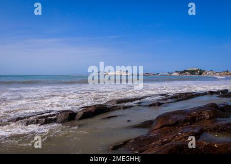 Far View to the Cape Coast Slave Castle from the  Atlantic Ocean Coastline in Ghana, West Africa Stock Photo