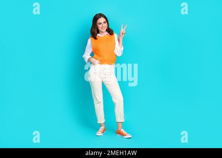 Full body size photo cadre of young peaceful lady wear formal uniform schoolgirl teacher trendy show v-sign isolated on aquamarine color background Stock Photo