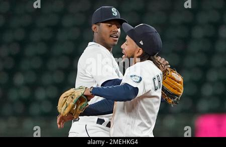 Seattle Mariners' Kyle Lewis, left, is greeted by Taylor Trammell