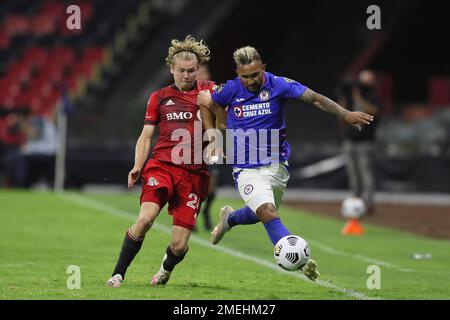 Jacob Shaffelburg of Canada's Toronto FC (24) heads the ball challenged by  Rafael Baca of Mexico's Cruz Azul during a CONCACAF Champions League  quarterfinal second leg soccer match at Azteca stadium in