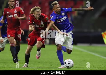 Jacob Shaffelburg of Canada's Toronto FC (24) heads the ball challenged by  Rafael Baca of Mexico's Cruz Azul during a CONCACAF Champions League  quarterfinal second leg soccer match at Azteca stadium in