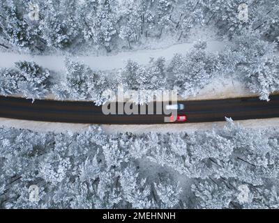 Aerial view of road in snow Rothiemurchus forest  in Cairngorms national Park, Scottish Highlands, Scotland, UK Stock Photo