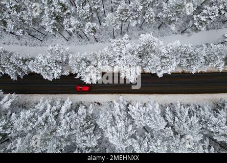 Aerial view of road in snow Rothiemurchus forest  in Cairngorms national Park, Scottish Highlands, Scotland, UK Stock Photo