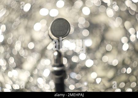 Podcasting concept, vintage recording microphone on bubble bokeh balls  in the background, close up with selective focus Stock Photo