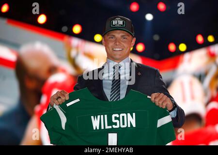 BYU quarterback Zach Wilson holds a New York Jets jersey on stage