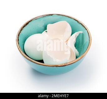 Blue bowl with eggshell isolated. Eggshell in bowl on white background. Stock Photo