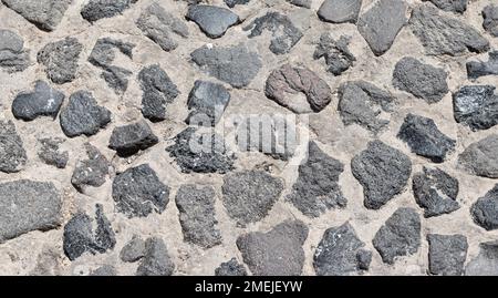 Cobblestone pavement texture as background. Stock Photo