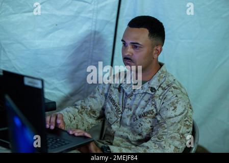 U.S. Marine Corps Staff Sgt. Jose Gandiafuret, a cyber warfare operator with Marine Corps Cyberspace Operations Battalion, Marine Corps Cyberspace Forces, scans the network during exercise Native Fury 22 at the Yanbu Commercial Port, Kingdom of Saudi Arabia, Aug. 17, 2022. Native Fury 22 is vital for strengthening the United States’ long-standing relationship with Saudi Arabian Armed Forces. The exercise enhances combined tactics, maritime capabilities and promotes long-term regional stability. Stock Photo
