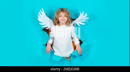 Smiling child angel in paper hole. Valentines angels. Little cupid boy. Valentines day gift card. Stock Photo