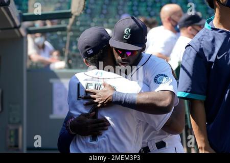 Seattle Mariners' Kyle Lewis, left, is greeted by Taylor Trammell