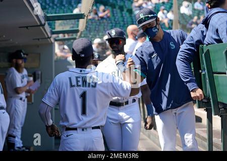 Seattle Mariners' Kyle Lewis, left, is greeted by Taylor Trammell