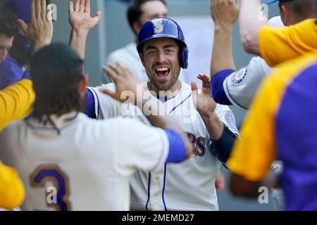 Seattle Mariners' Tom Murphy reacts in the dugout after he hit a