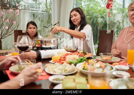 Big family enjoying tasty dishes cooked for spring festival Stock Photo