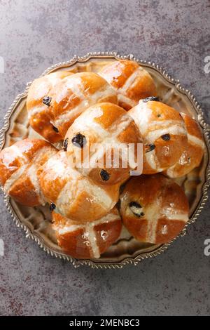 Easter Breakfast with Hot Cross Buns closeup on the plate on the table. Vertical top view from above Stock Photo