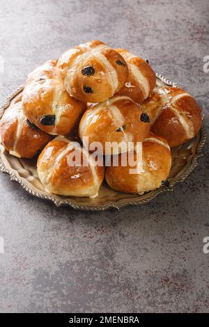 Easter Breakfast with Hot Cross Buns closeup on the plate on the table. Vertical Stock Photo