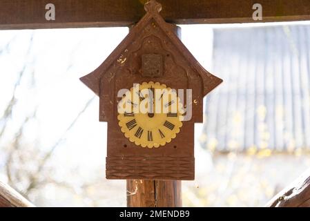 Old rustic clock on a light background. Stock Photo