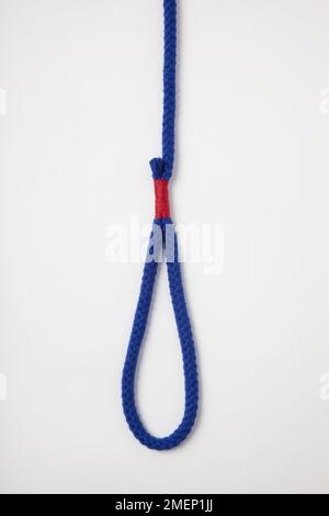 Stitch and Seize, whipping in red twine around blue rope, to make a permanent eye on the end of a braided rope (whipping) Stock Photo