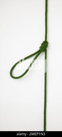 Single Figure-of-Eight Loop on the Bight, knot tied in green rope, in the middle of the rope Stock Photo