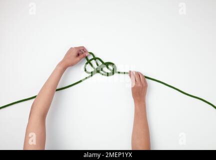 Single Figure-of-Eight Loop on the Bight, tied in the middle of the rope, Step 4 Stock Photo