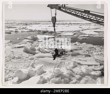 Fearless USCG Photographer Elmo Jones shooting from the crane on USCGC EASTWIND. Stock Photo