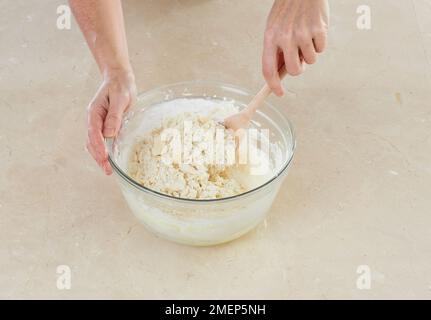 Making Shortbread, stirring in flour and cornflour Stock Photo