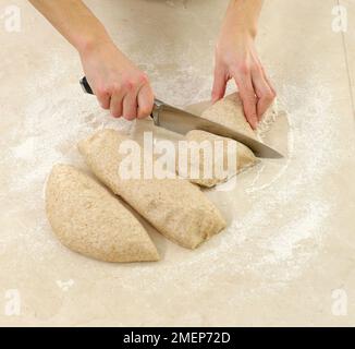 Wholemeal Cottage Loaf, cutting dough into pieces Stock Photo