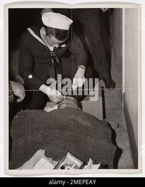 Coast Guardsman Don Molony of Detroit is credited with saving at least a dozen lives after an Army bomber crashed into the Empire State Building. As a 17-year-old Hospital Apprentice, Molony administered first aid to a New York City fireman overcome by smoke on the 79th floor. Molony's swift actions during this dramatic rescue earned him recognition as a hero of the 1945 crash. Stock Photo