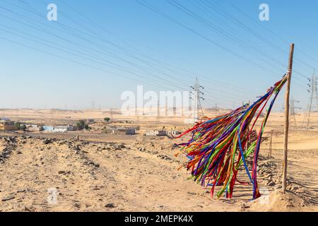 Colorful stripes of textile flying with the wind and movement for decoration in a nubian village in Egypt Stock Photo