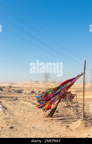 Vertical view of Colorful stripes of textile flying with the wind and movement for decoration in a nubian village in Egypt Stock Photo