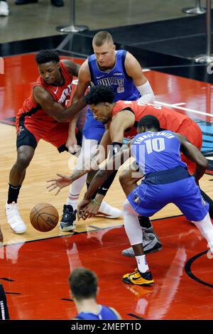 Christian Wood of the Houston Rockets dunks the ball over Kristaps