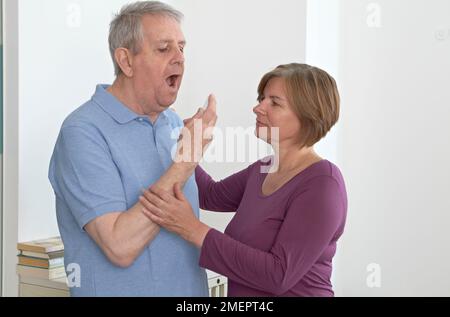 Taking medication for angina attack Stock Photo