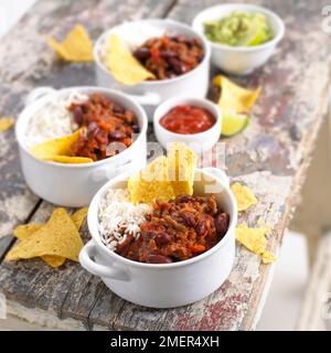 Three individual portions of chilli con carne, rice and tortilla chip Stock Photo