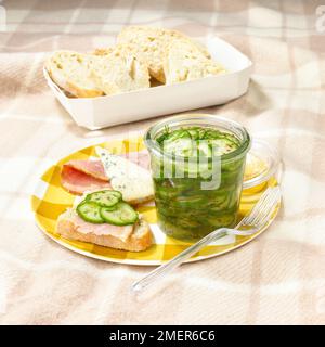 Ham and sliced bread and jar of cucumber and dill pickle Stock Photo