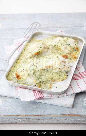 Tray of cod in mustard parsley sauce Stock Photo