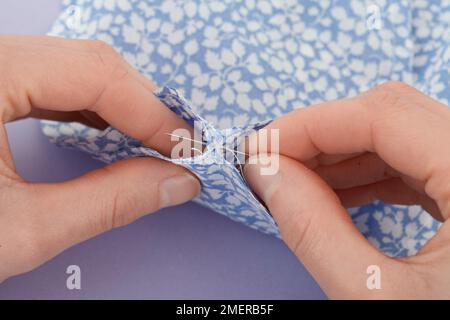 Sewing body of pieces of fabric together Stock Photo